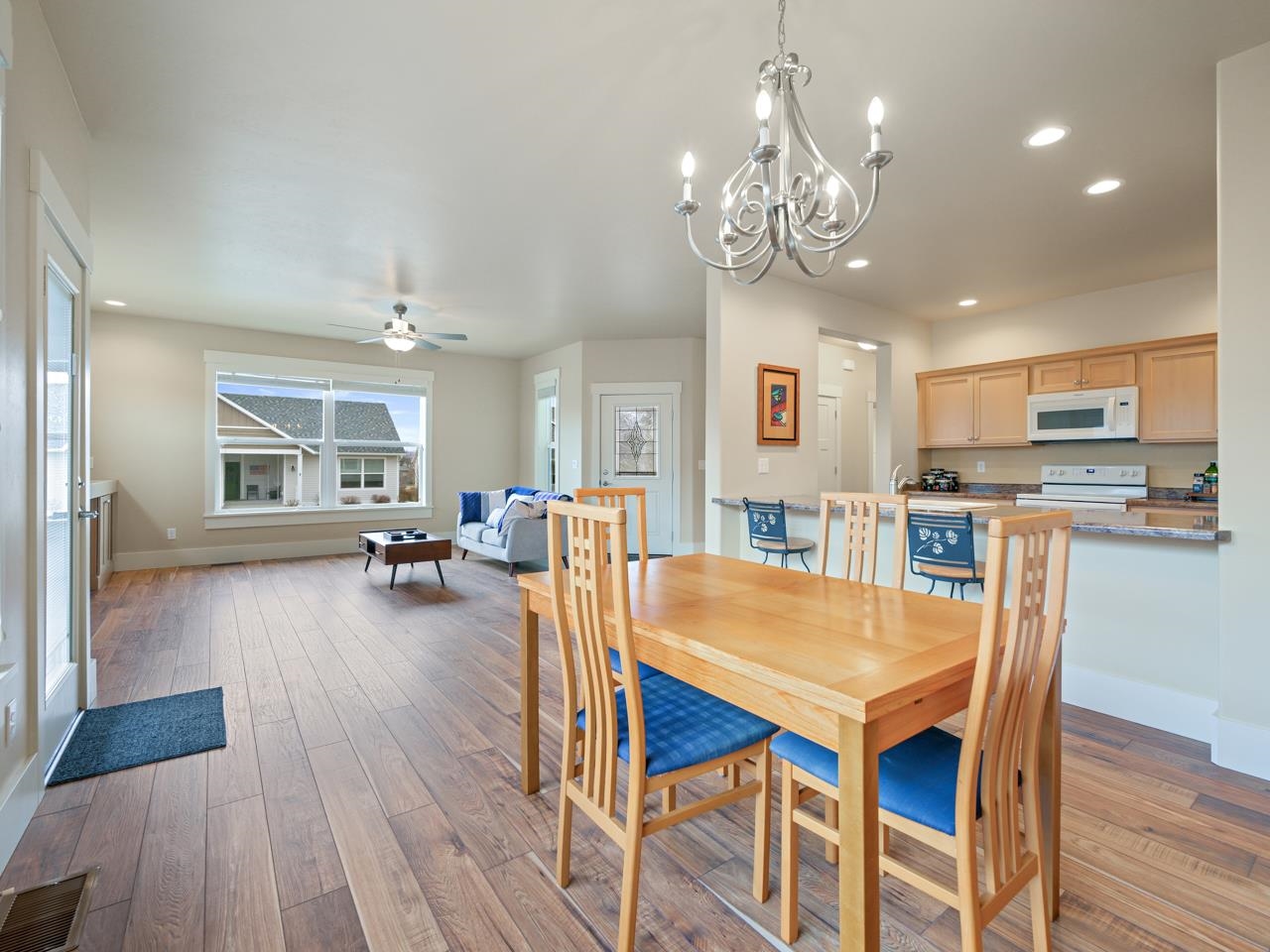 1245 Periwinkle Street Fruita, CO 81521 - Photo 9 of 34 a dining room with wooden floor and chandelier