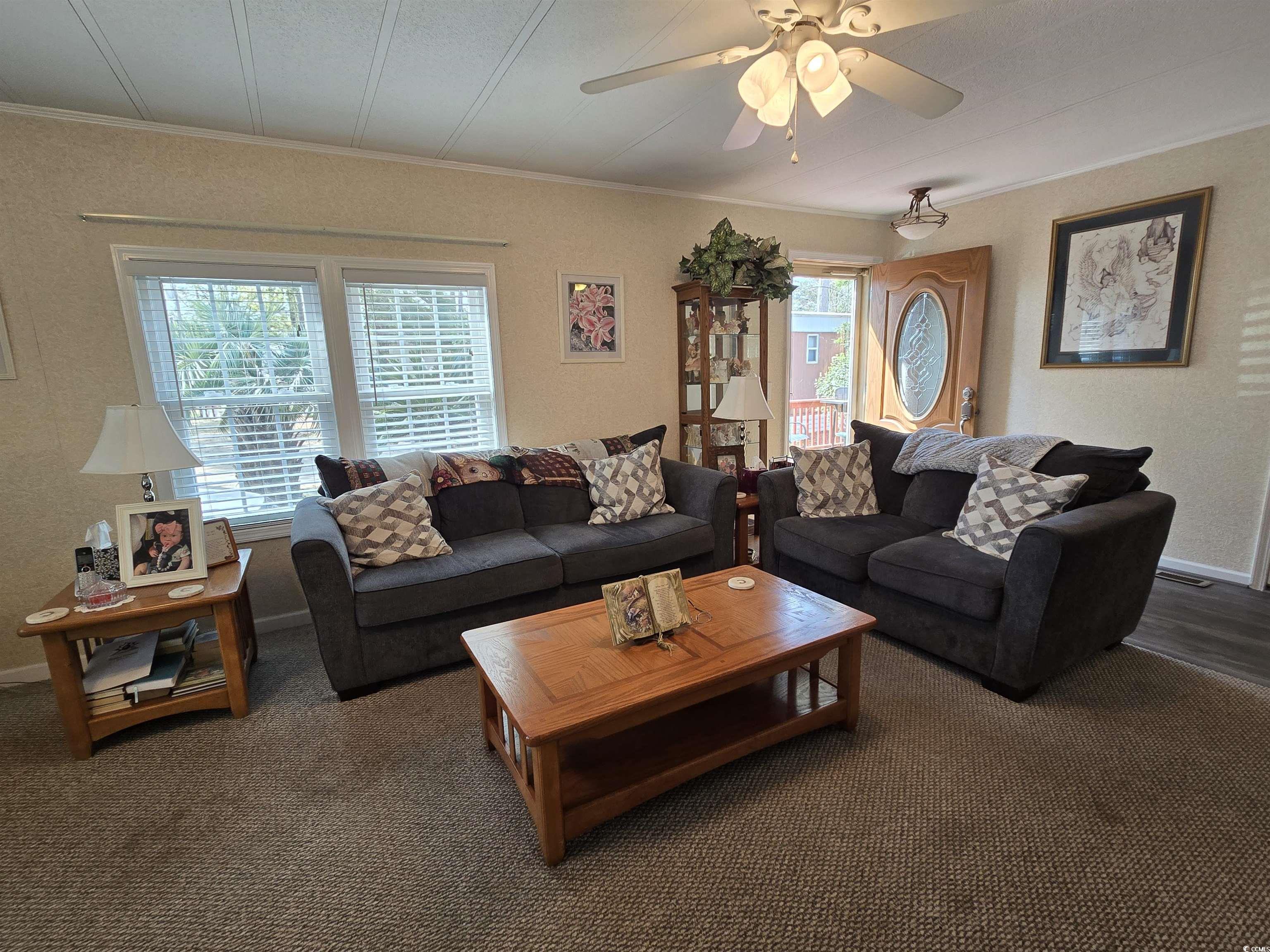 420 Delton Drive Murrells Inlet, SC 29576 - Photo 12 of 36 Carpeted living area with crown molding and ceiling fan