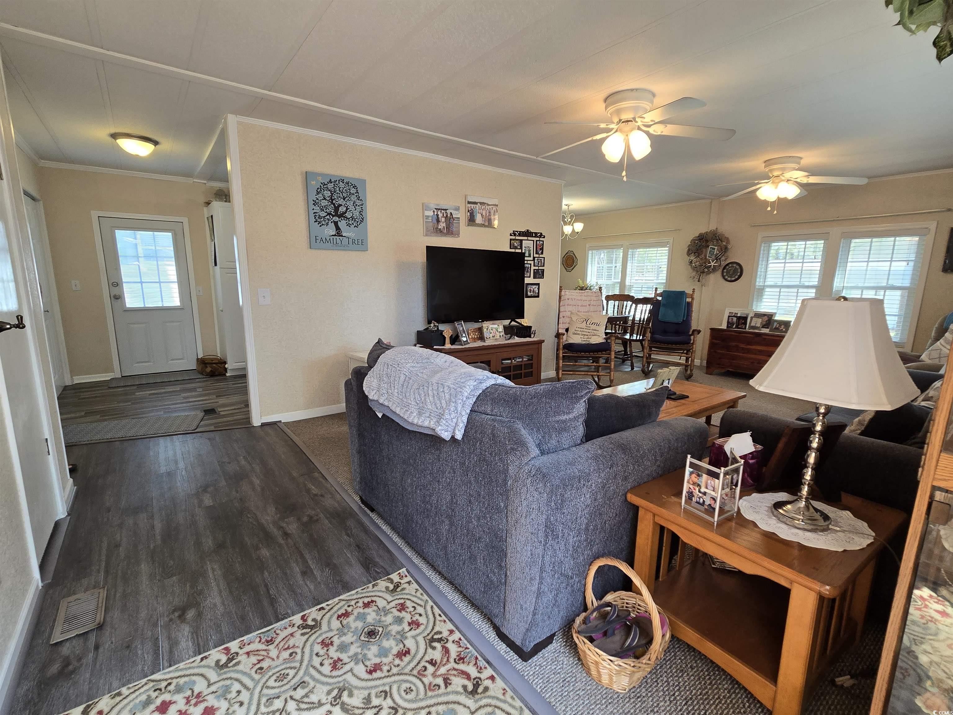420 Delton Drive Murrells Inlet, SC 29576 - Photo 13 of 36 Living area featuring dark wood-type flooring, plenty of natural light, a ceiling fan, and ornamental molding
