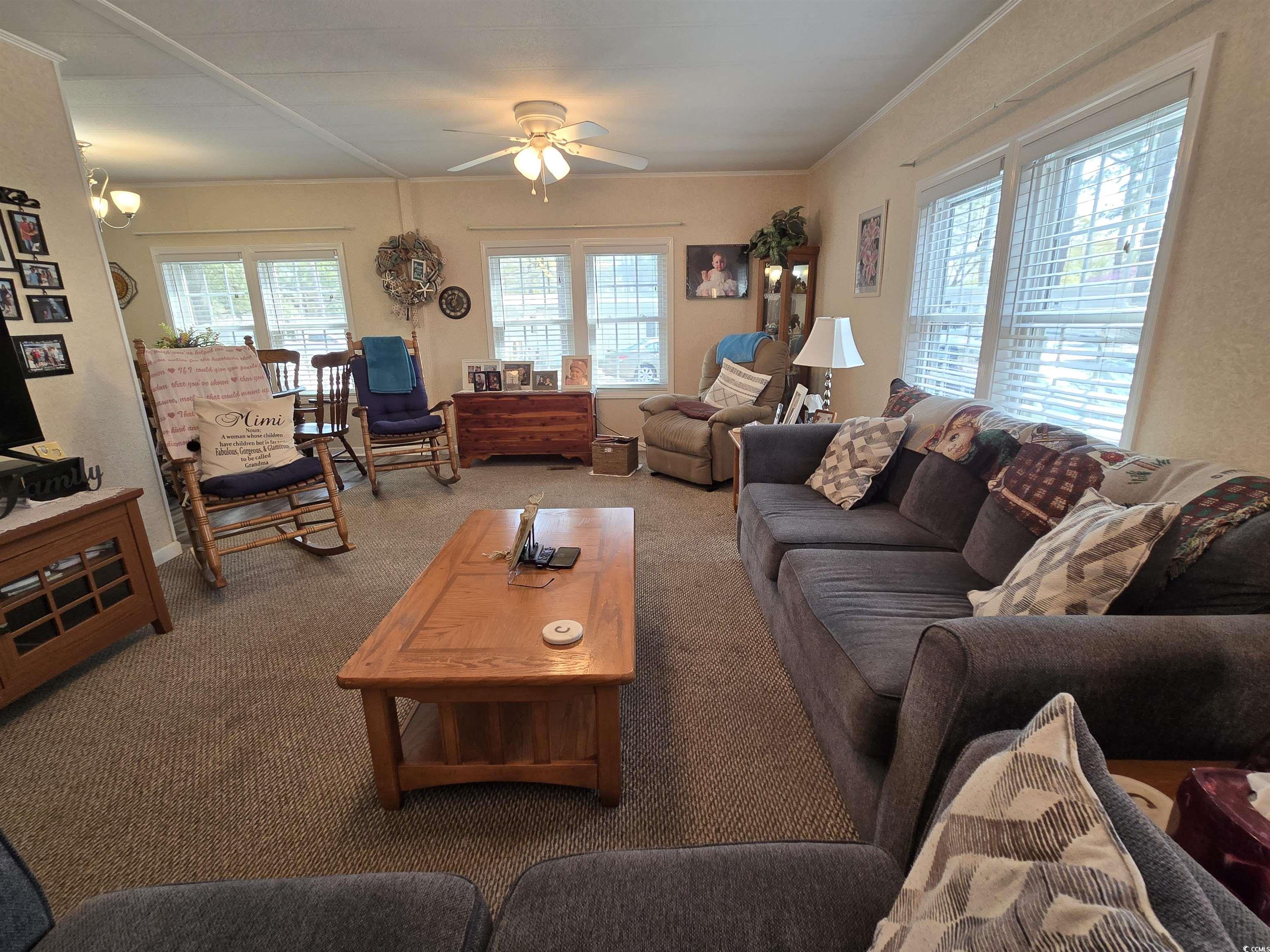 420 Delton Drive Murrells Inlet, SC 29576 - Photo 15 of 36 Carpeted living area with healthy amount of natural light and ceiling fan