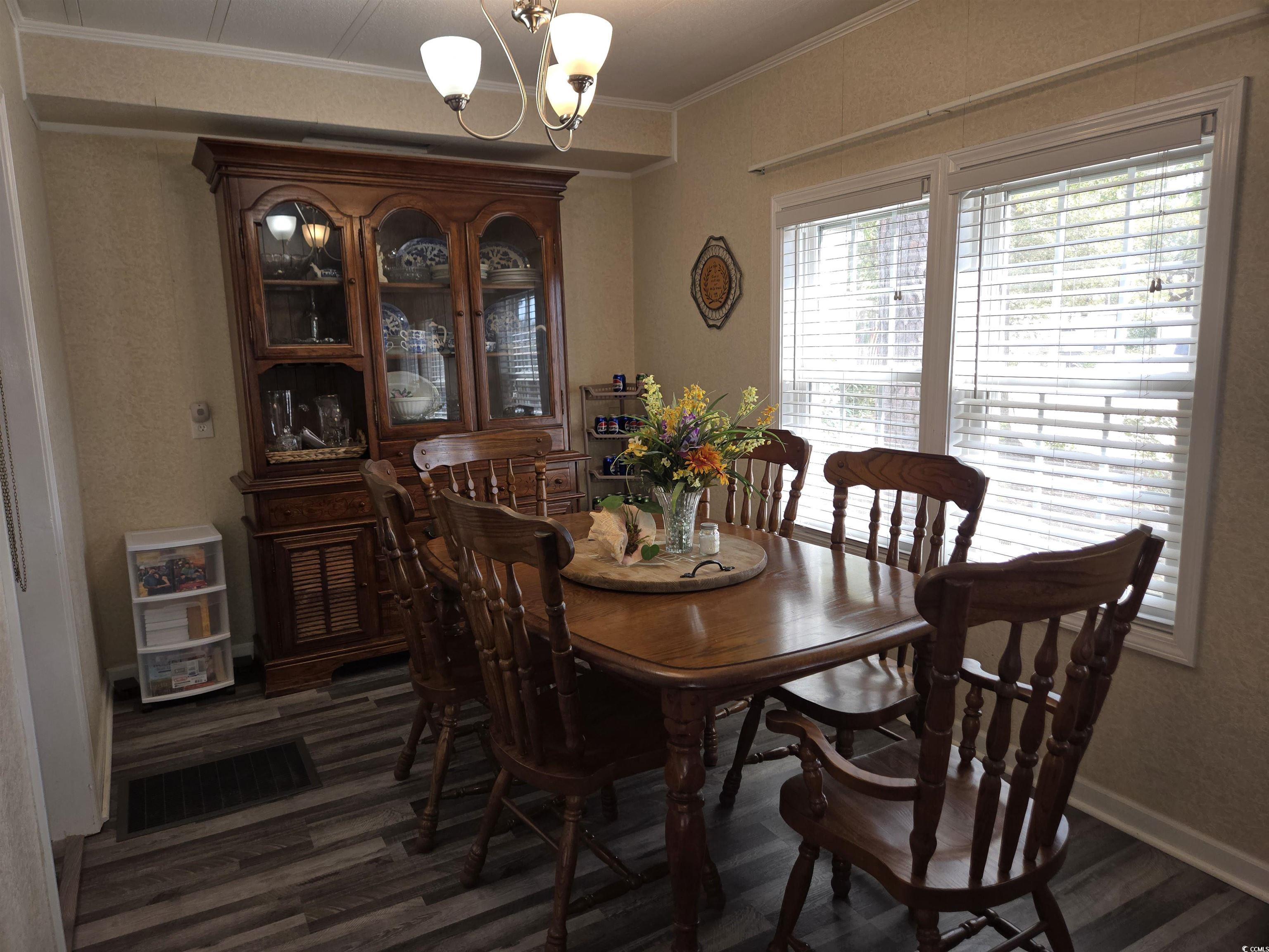 420 Delton Drive Murrells Inlet, SC 29576 - Photo 16 of 36 Dining space with a chandelier, crown molding, and dark wood finished floors