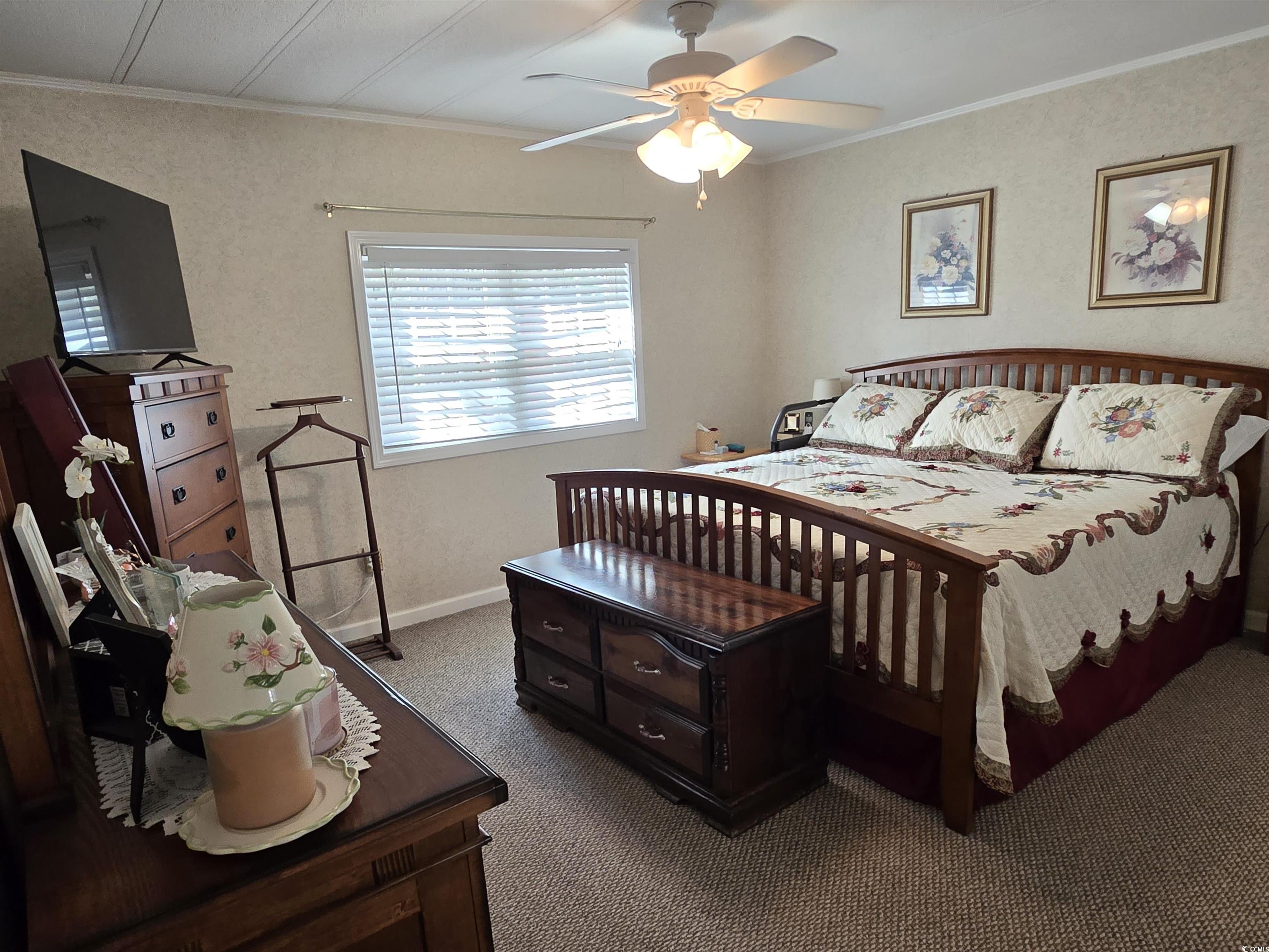 420 Delton Drive Murrells Inlet, SC 29576 - Photo 23 of 36 Bedroom featuring crown molding, carpet floors, and a ceiling fan