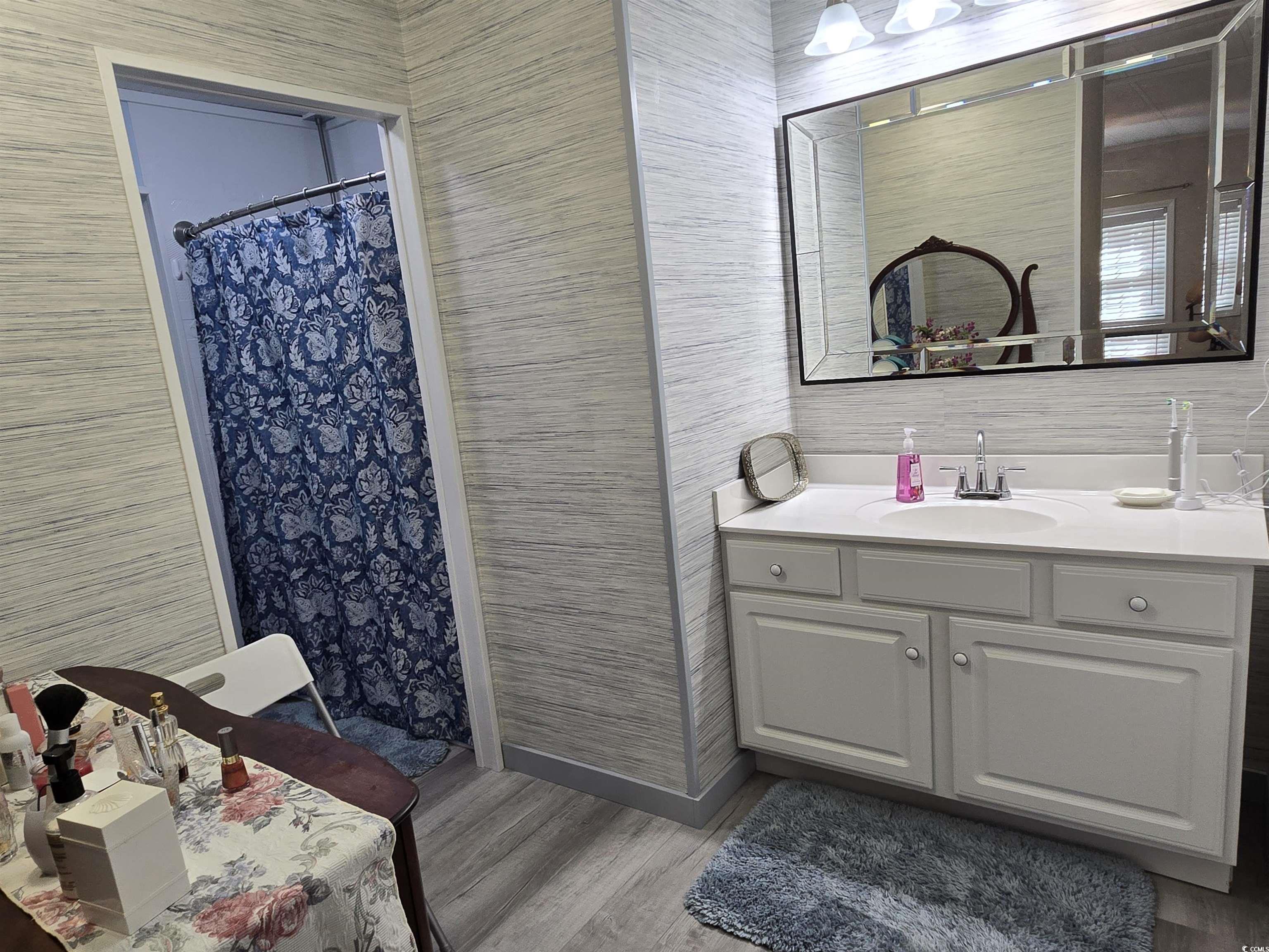 420 Delton Drive Murrells Inlet, SC 29576 - Photo 33 of 36 Bathroom with vanity, light wood finished floors, a shower stall, and tile walls