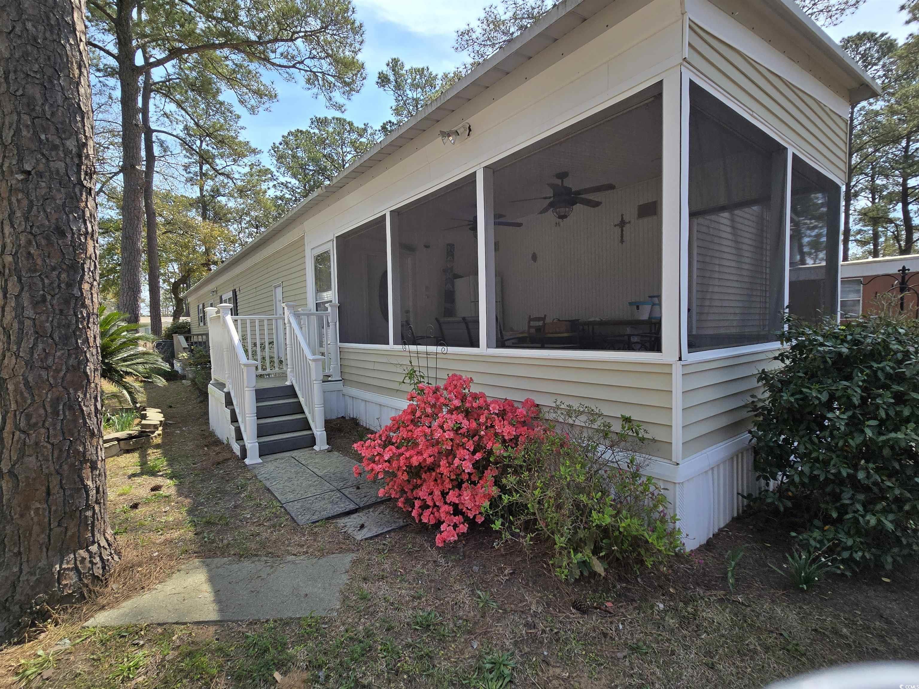420 Delton Drive Murrells Inlet, SC 29576 - Photo 5 of 36 View of property exterior featuring a sunroom and ceiling fan