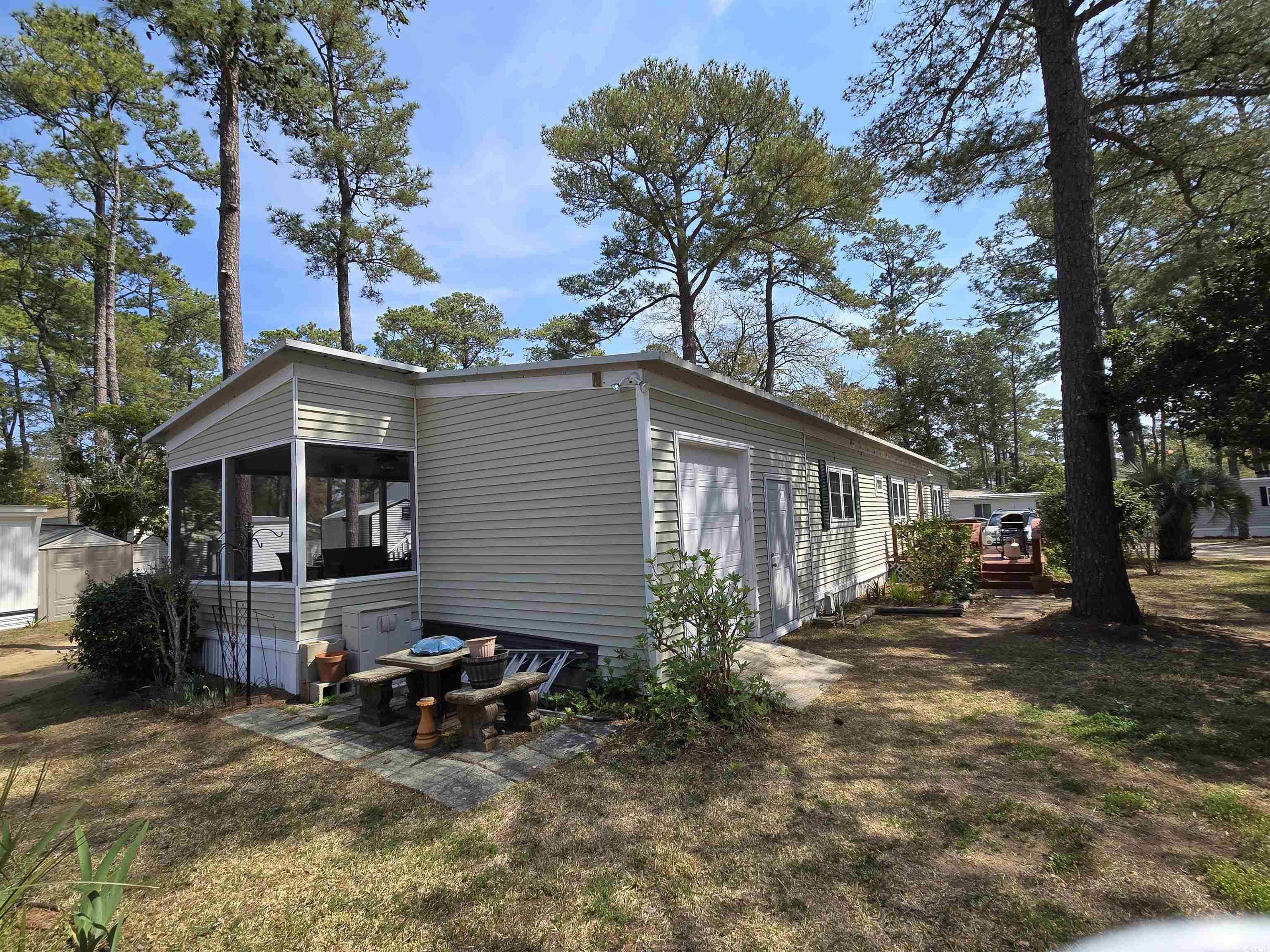 420 Delton Drive Murrells Inlet, SC 29576 - Photo 6 of 36 View of side of home featuring a lawn and a sunroom