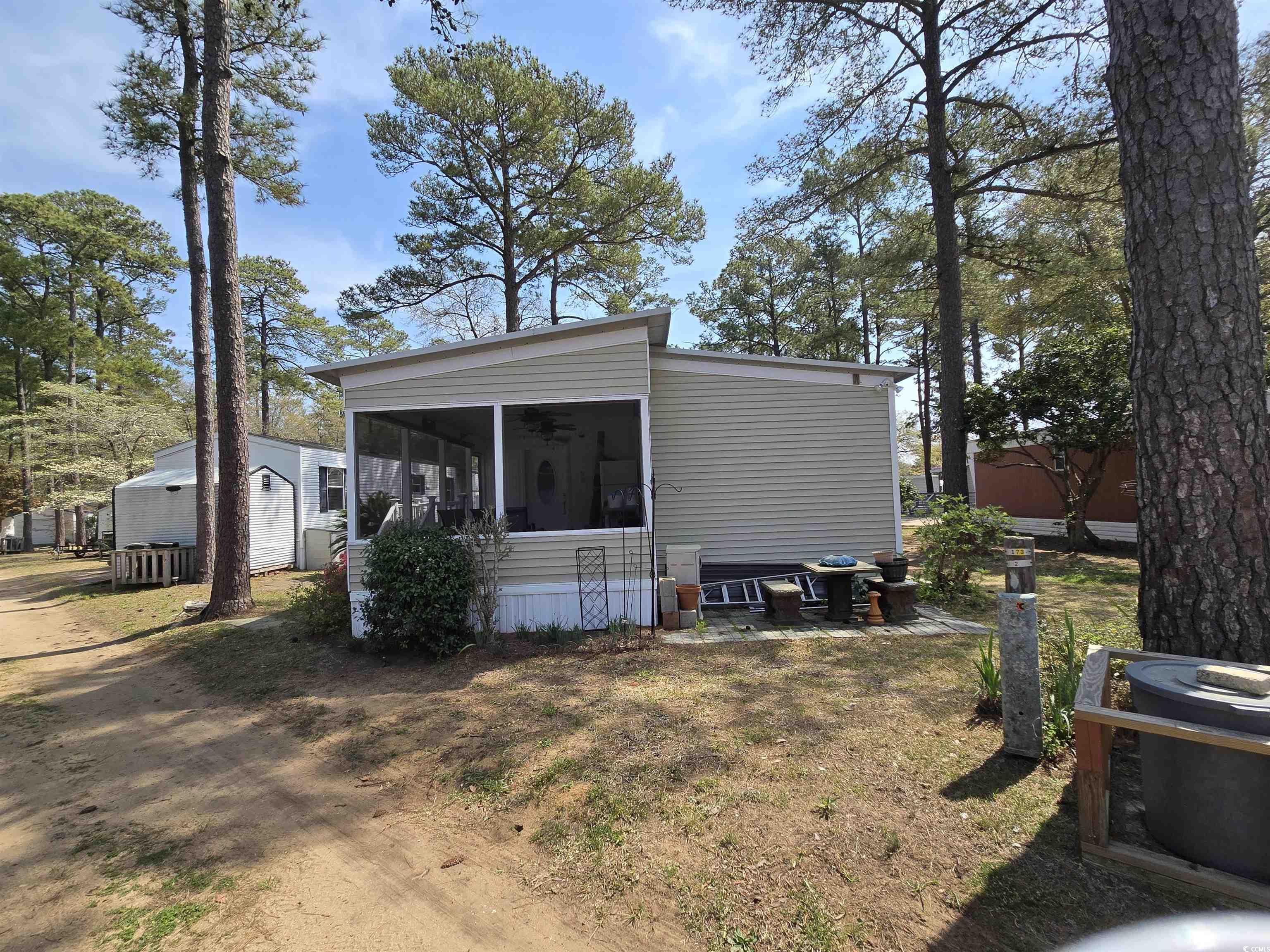420 Delton Drive Murrells Inlet, SC 29576 - Photo 10 of 36 Rear view of property with a sunroom, a patio, and a lawn