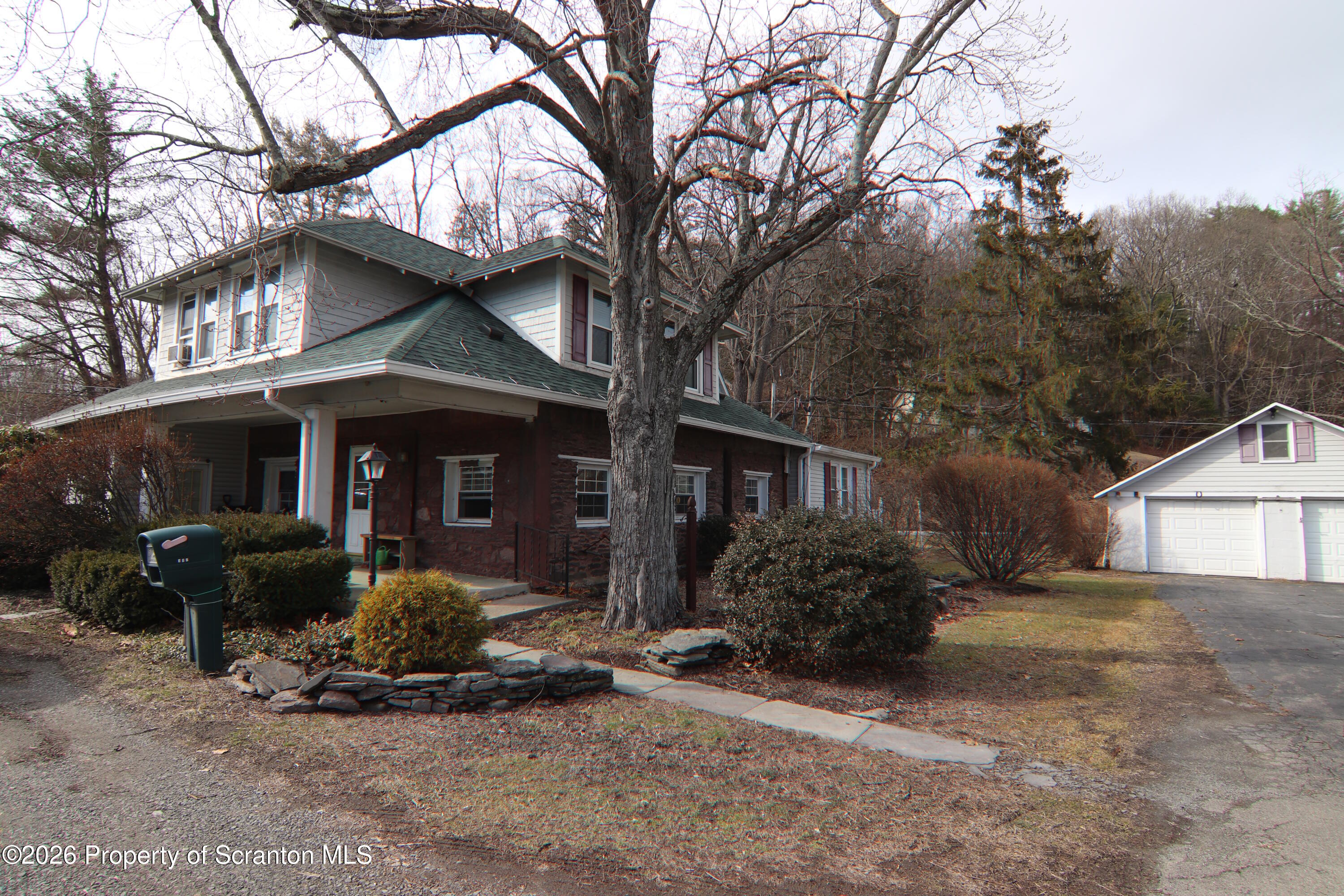 502 State Rte 92 South Tunkhannock, PA 18657 - Photo 51 of 52 a front view of a house with garden and trees