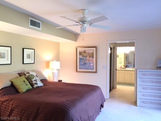3021 Matecumbe Key Road, Unit 2 Punta Gorda, FL 33955 - Photo 14 of 24 a bedroom with a bed and a chandelier