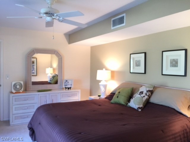 3021 Matecumbe Key Road, Unit 2 Punta Gorda, FL 33955 - Photo 15 of 24 a bedroom with a large bed and a mirror