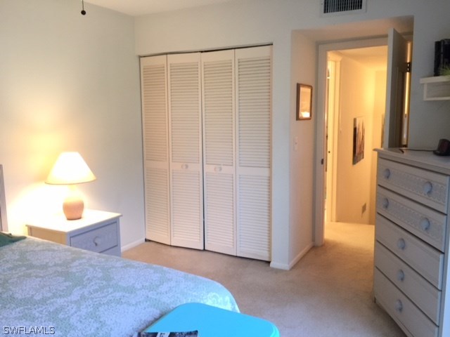3021 Matecumbe Key Road, Unit 2 Punta Gorda, FL 33955 - Photo 19 of 24 a bedroom with a bed and a lamp