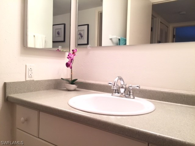3021 Matecumbe Key Road, Unit 2 Punta Gorda, FL 33955 - Photo 20 of 24 a bathroom with a sink and a mirror