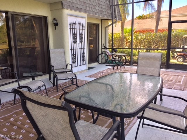 3021 Matecumbe Key Road, Unit 2 Punta Gorda, FL 33955 - Photo 7 of 24 a dining room with furniture a rug and a large window