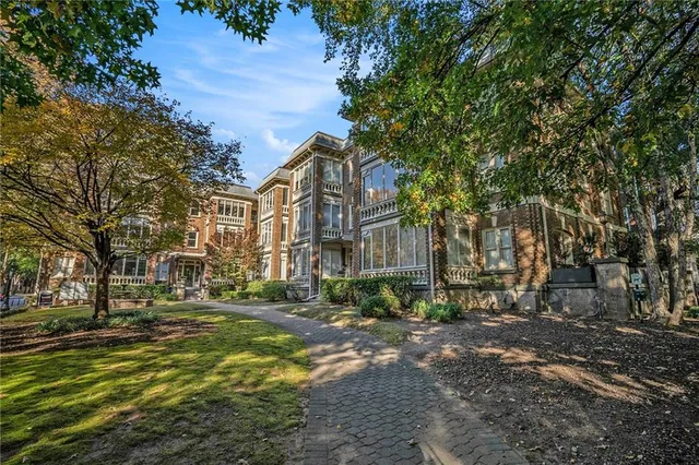 a front view of a residential apartment building with a yard