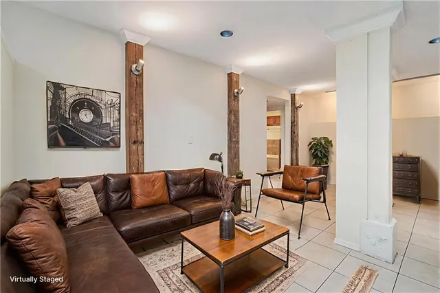 a living room with furniture a rug and a table