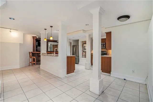 a view of a kitchen with furniture and an empty room