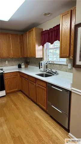 a kitchen with a sink cabinets and window