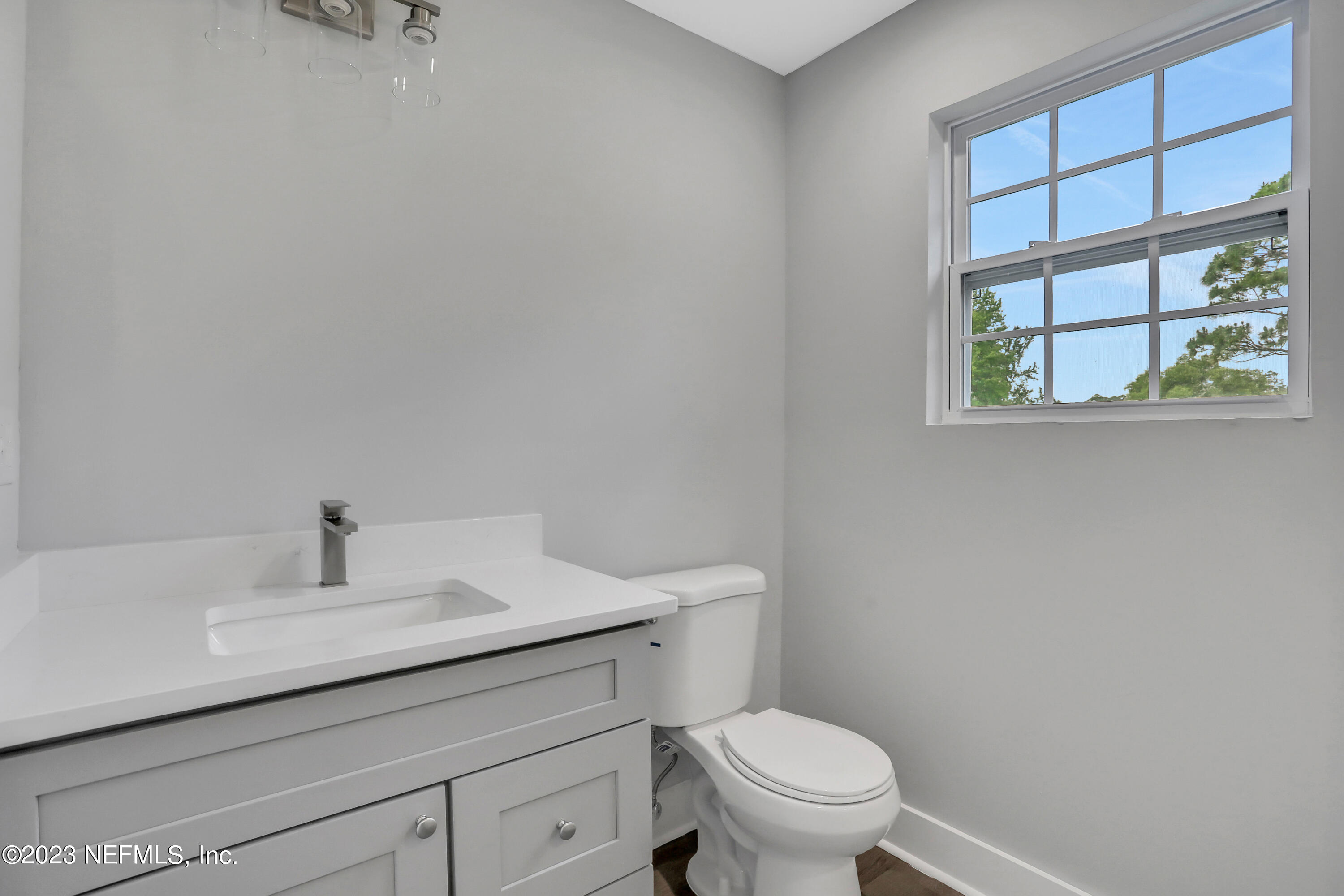 45195 Browns Farm Road Callahan, FL 32011 - Photo 13 of 24 a bathroom with a sink toilet and a window