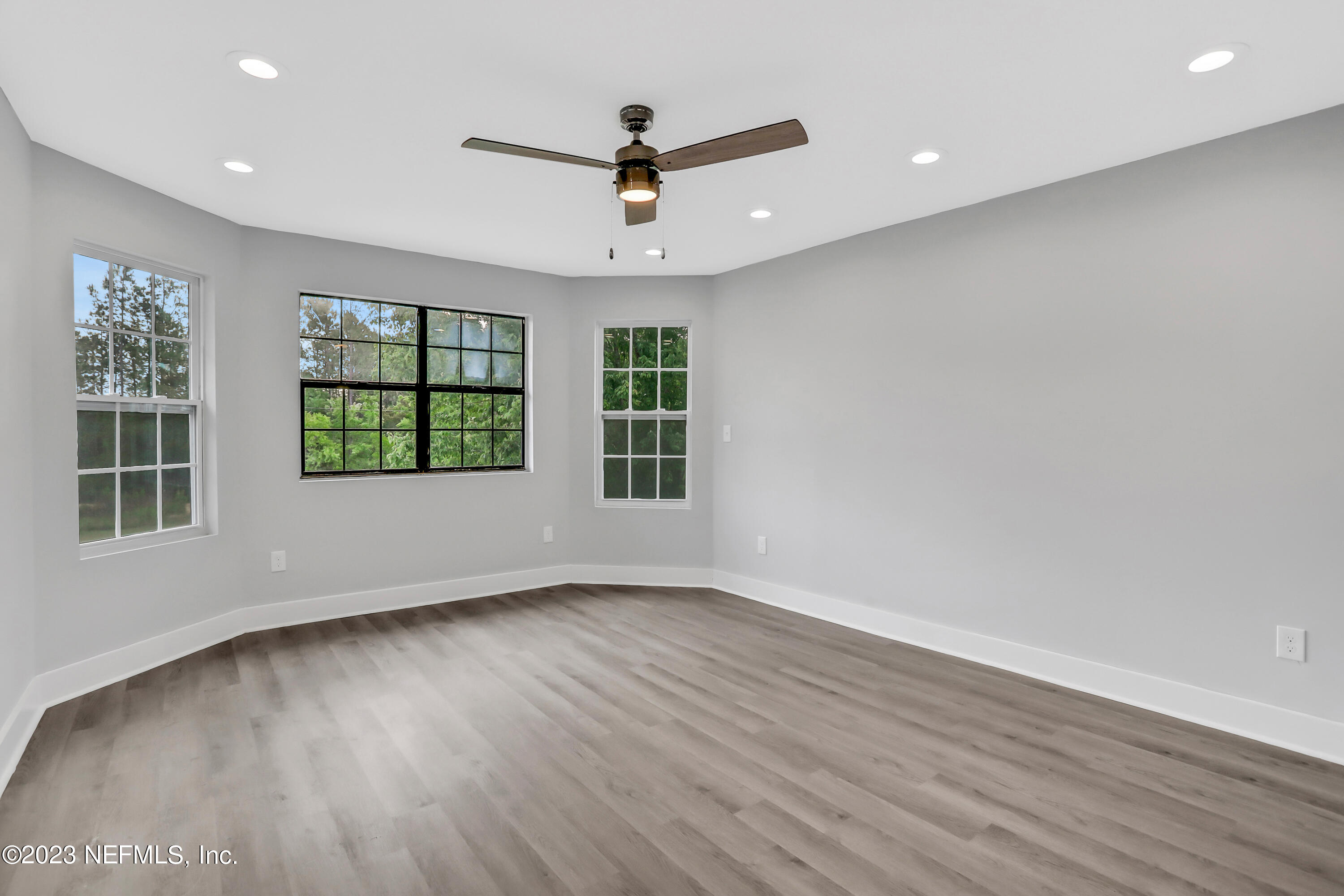 45195 Browns Farm Road Callahan, FL 32011 - Photo 14 of 24 an empty room with wooden floor chandelier and windows