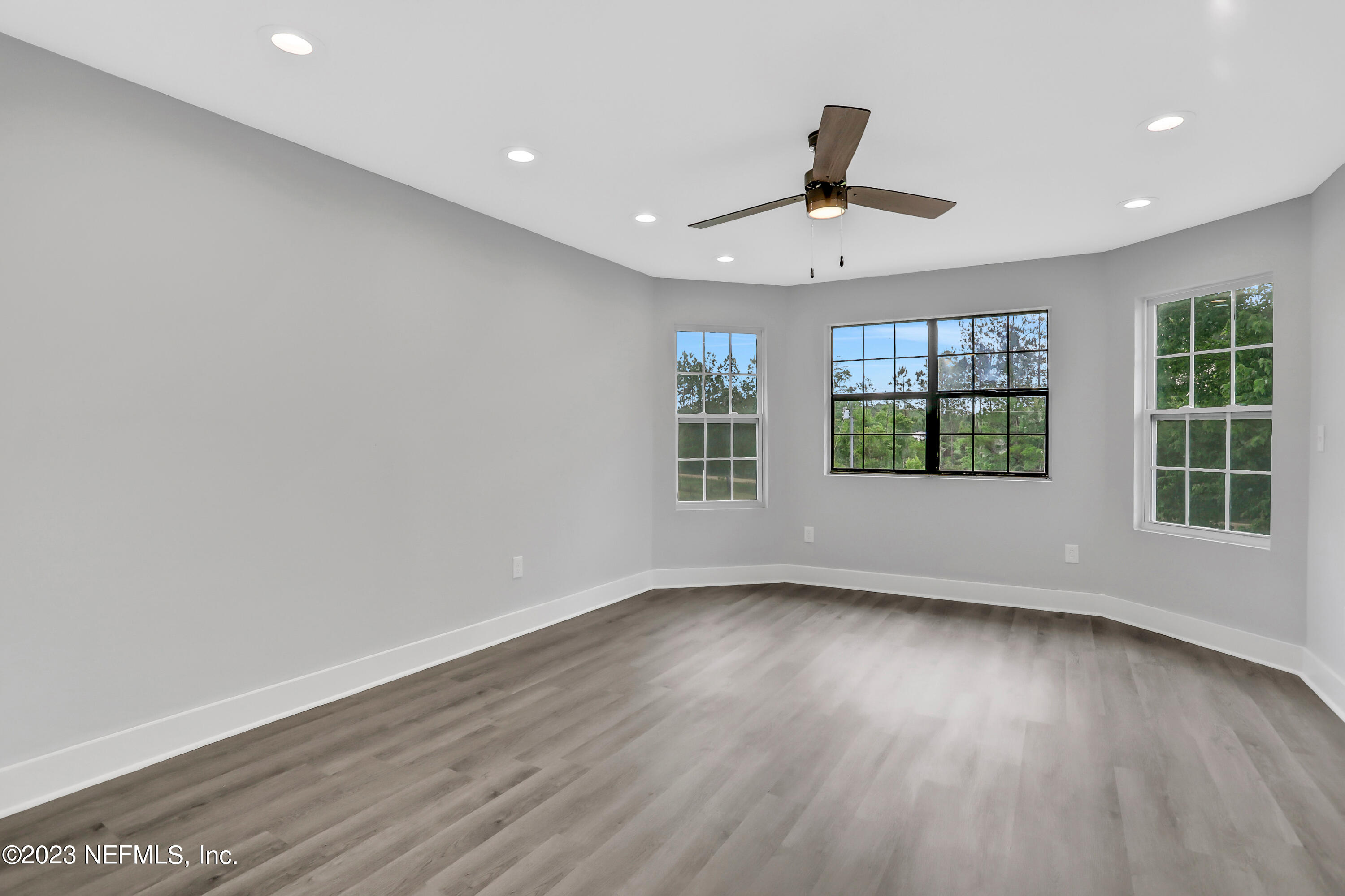 45195 Browns Farm Road Callahan, FL 32011 - Photo 15 of 24 a view of an empty room with wooden floor and a window