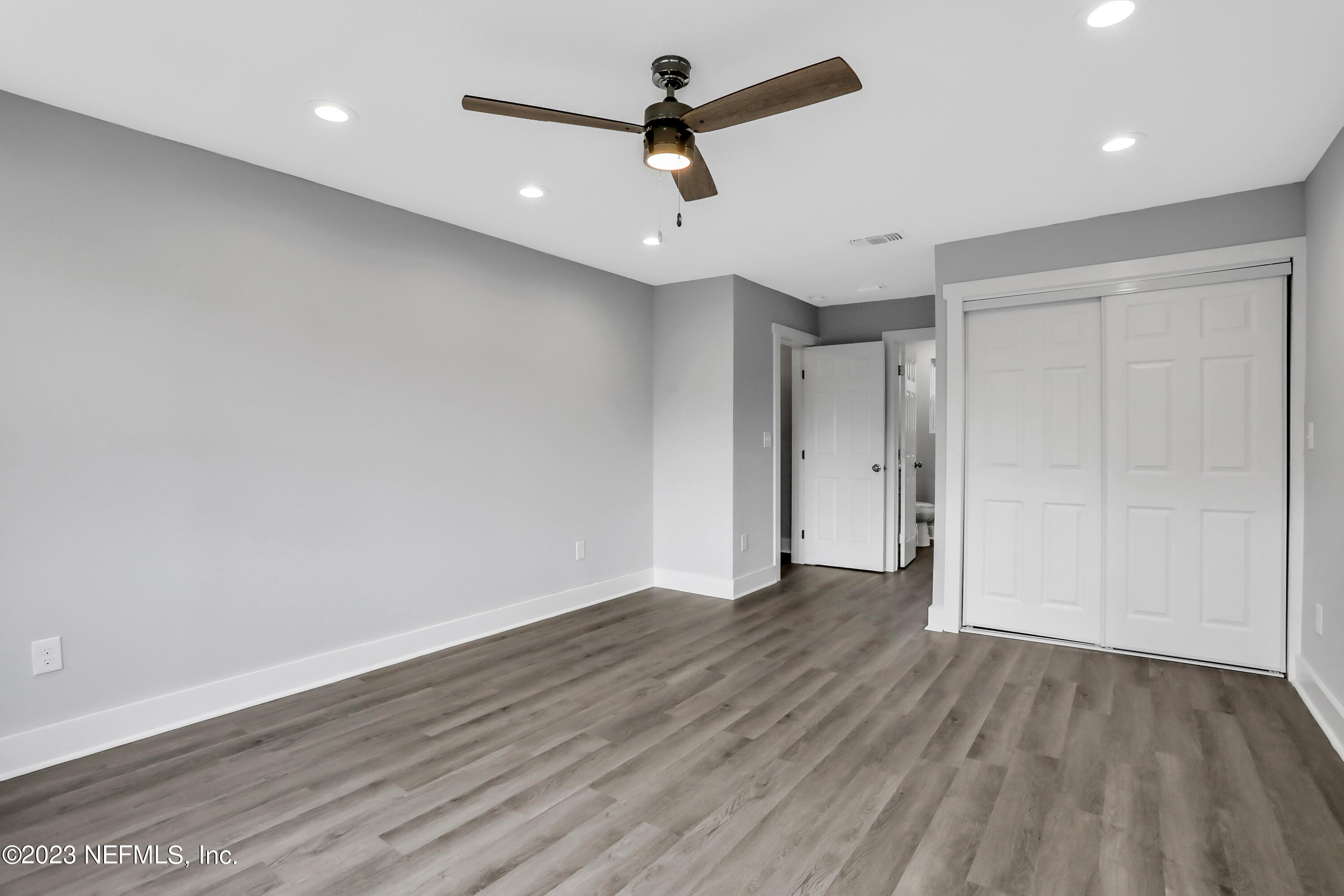 45195 Browns Farm Road Callahan, FL 32011 - Photo 16 of 24 an empty room with wooden floor ceiling fan and window
