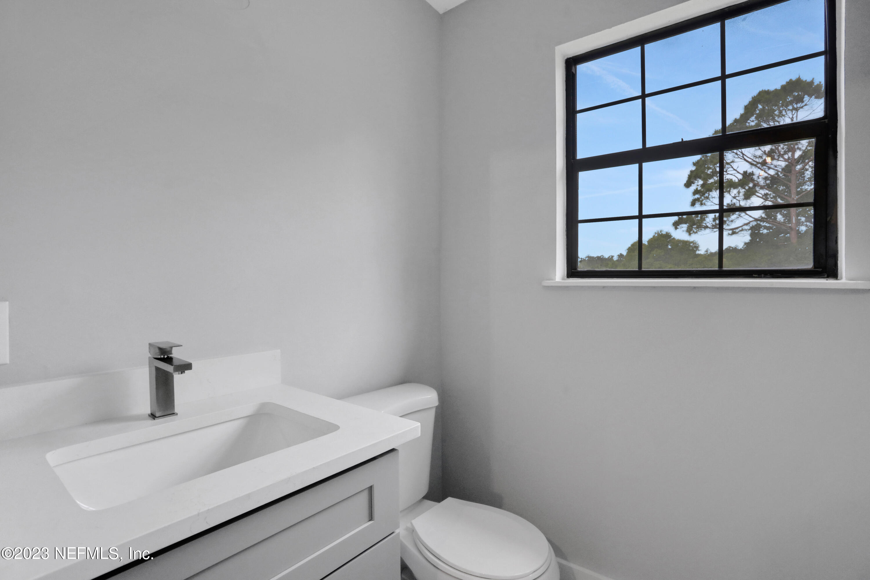 45195 Browns Farm Road Callahan, FL 32011 - Photo 17 of 24 a white toilet sitting next to a bathroom sink