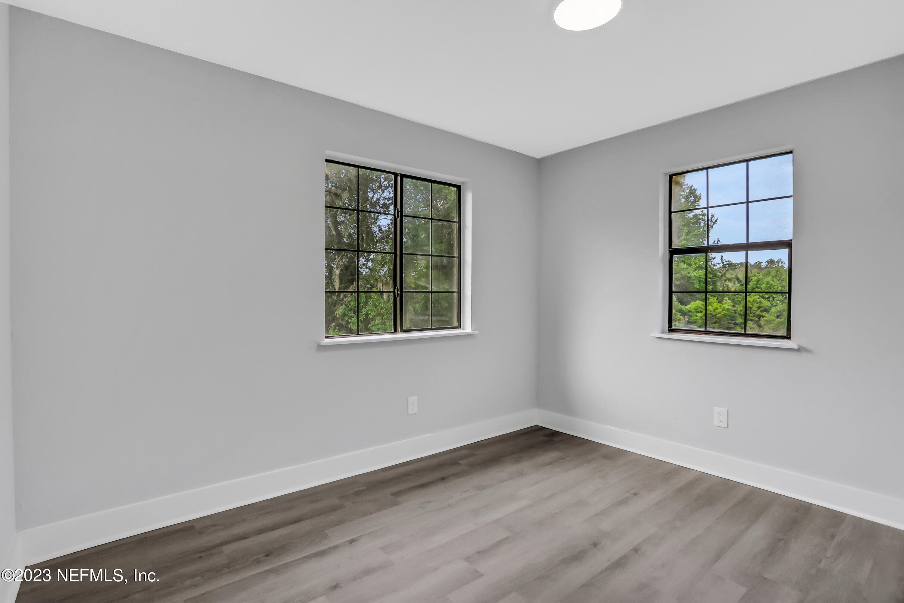 45195 Browns Farm Road Callahan, FL 32011 - Photo 19 of 24 an empty room with wooden floor and windows