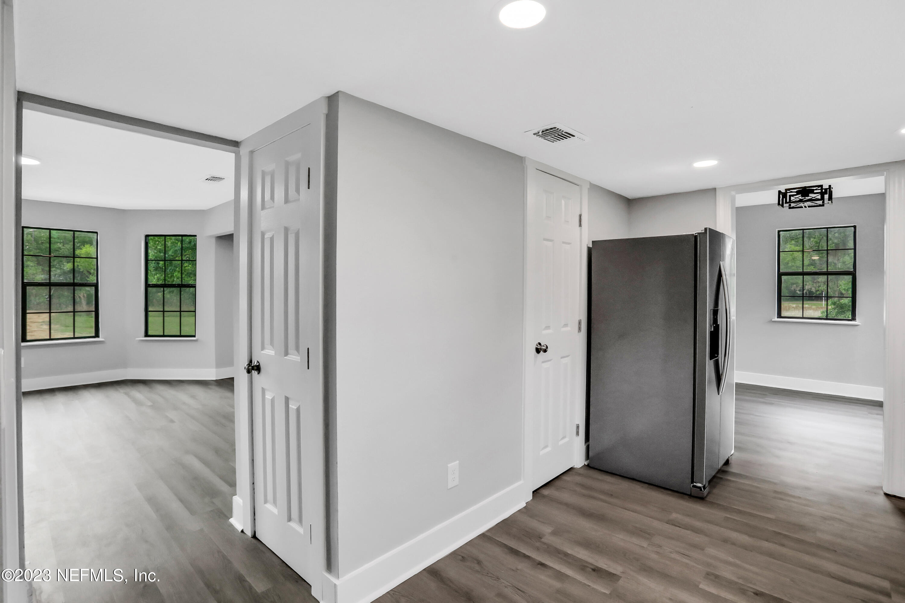45195 Browns Farm Road Callahan, FL 32011 - Photo 4 of 24 a view of an empty room with wooden floor and windows