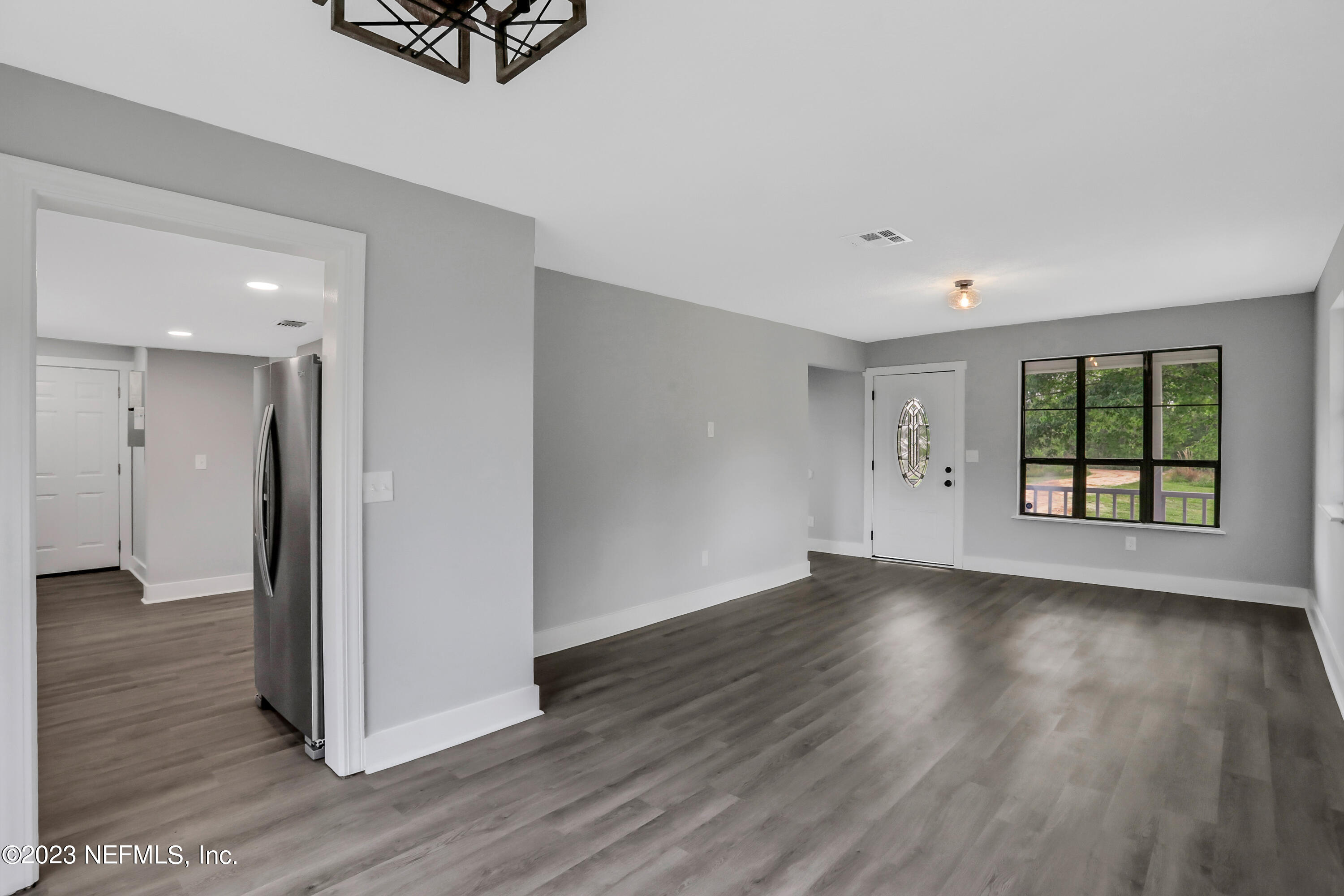 45195 Browns Farm Road Callahan, FL 32011 - Photo 6 of 24 an empty room with wooden floor and windows