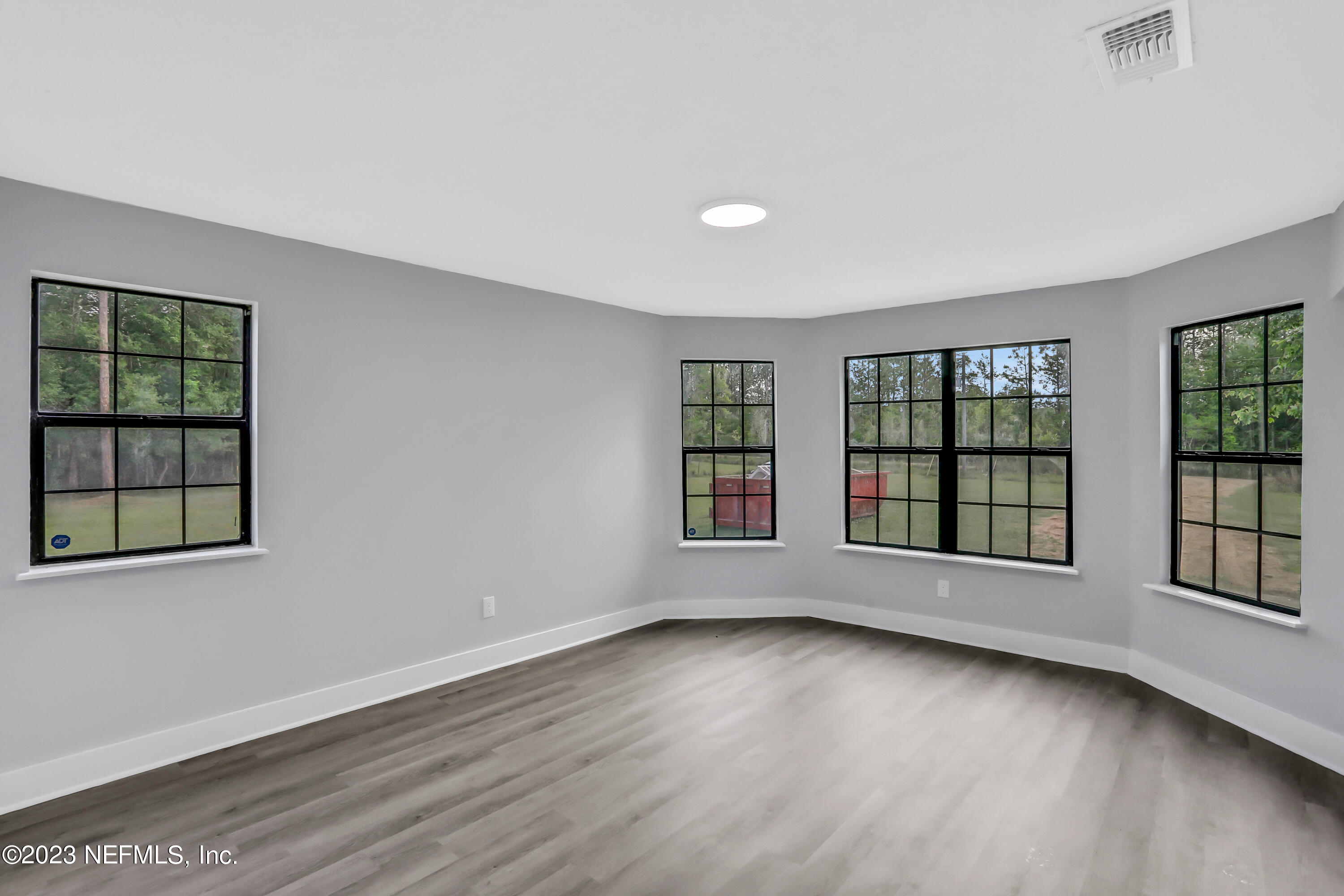 45195 Browns Farm Road Callahan, FL 32011 - Photo 7 of 24 a view of an empty room with a window and wooden floor
