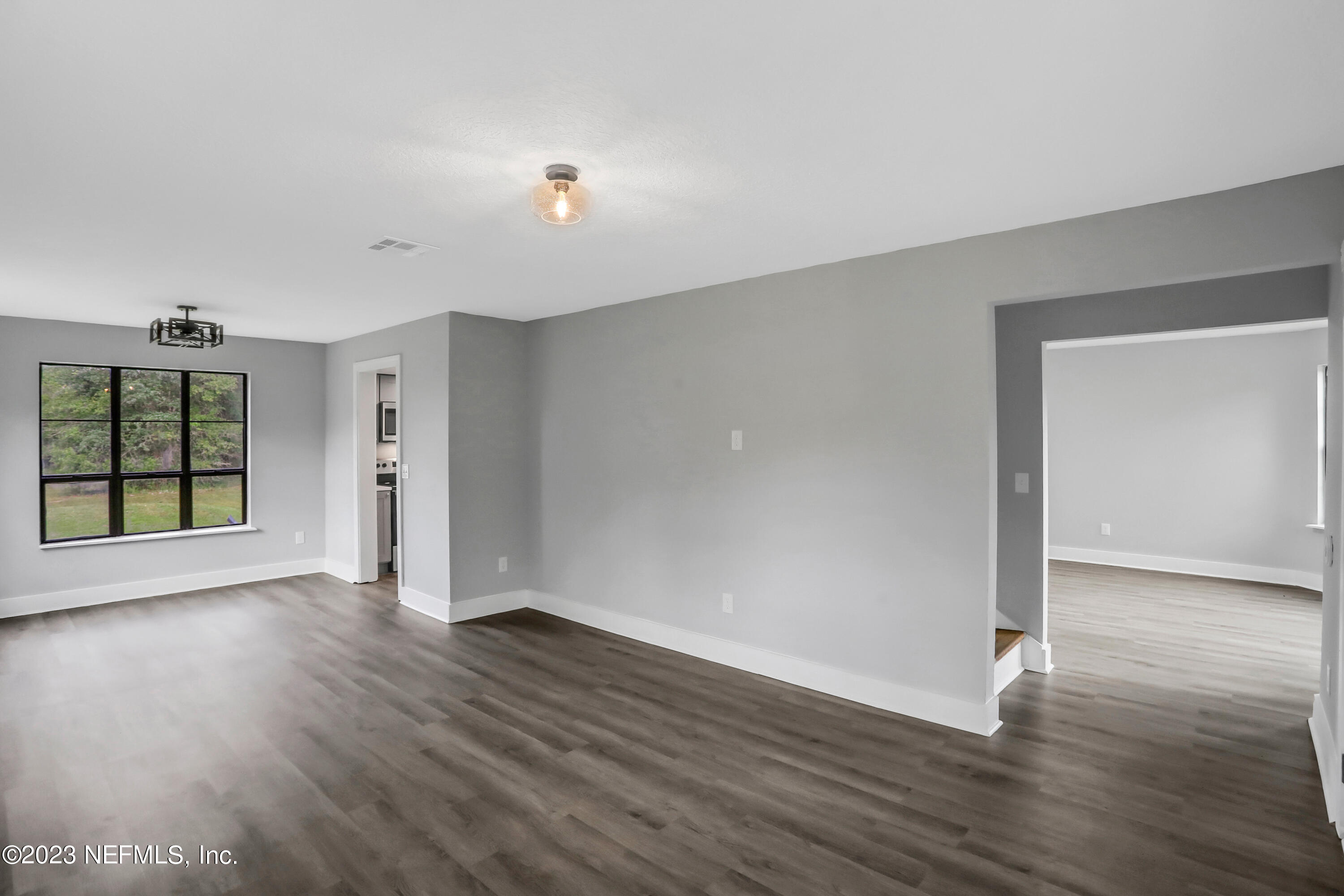 45195 Browns Farm Road Callahan, FL 32011 - Photo 9 of 24 an empty room with wooden floor and windows
