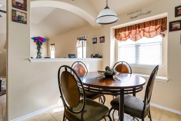 a dining room with furniture and window