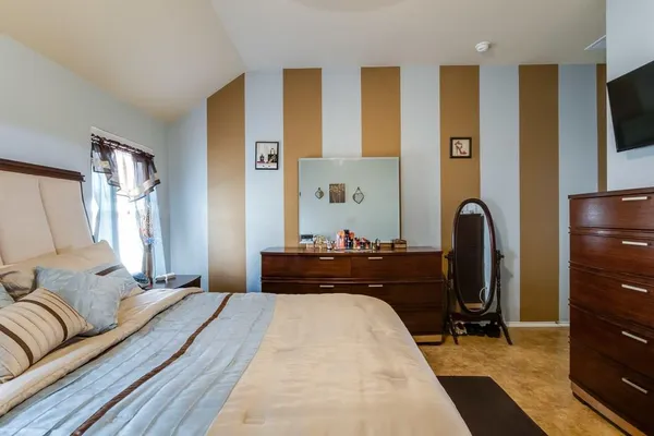a bed room with a bed and a television