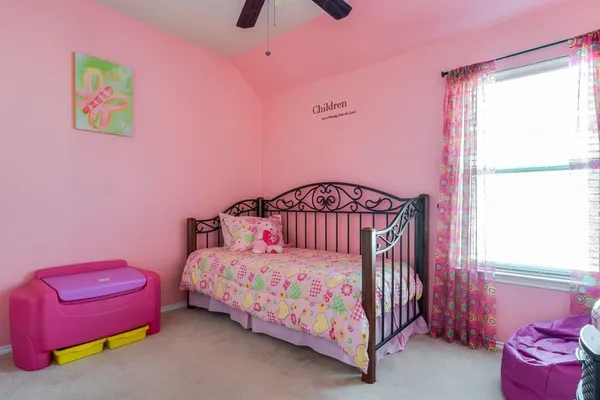 a bedroom with a bed a couch and a window
