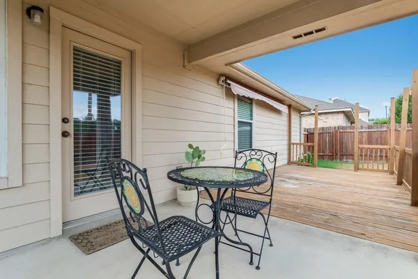 a backyard of a house with table and chairs