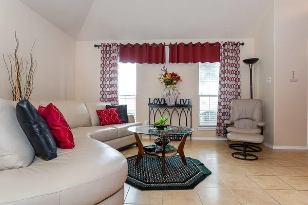 a living room with furniture and a chandelier
