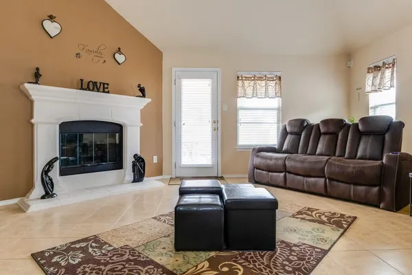 a living room with furniture window and a fireplace