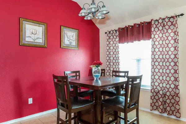 a view of a dining room with furniture and chandelier