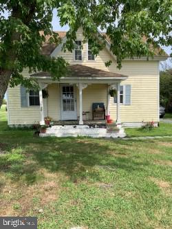 9409 Evans Road Berlin, MD 21811 - Photo 1 of 13 a front view of house with yard and trees in the background