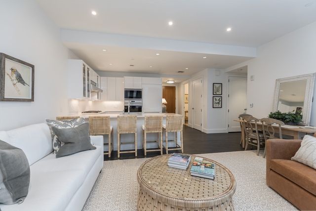 a living room with furniture kitchen and a table