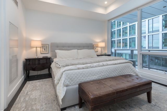 a bedroom with a bed and a large window