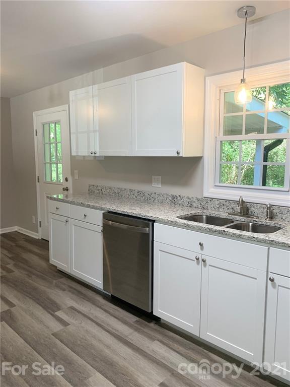 259 Roberta Road Concord, NC 28027 - Photo 6 of 12 a kitchen with granite countertop white cabinets and a window