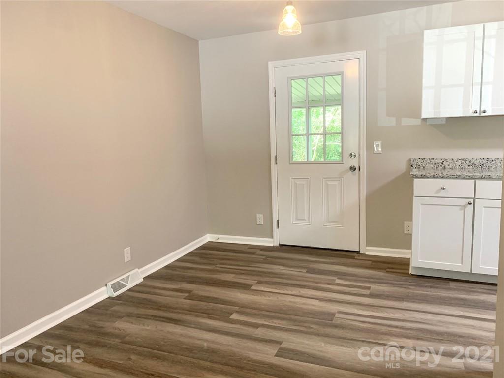 259 Roberta Road Concord, NC 28027 - Photo 7 of 12 a view of empty room with window and wooden floor