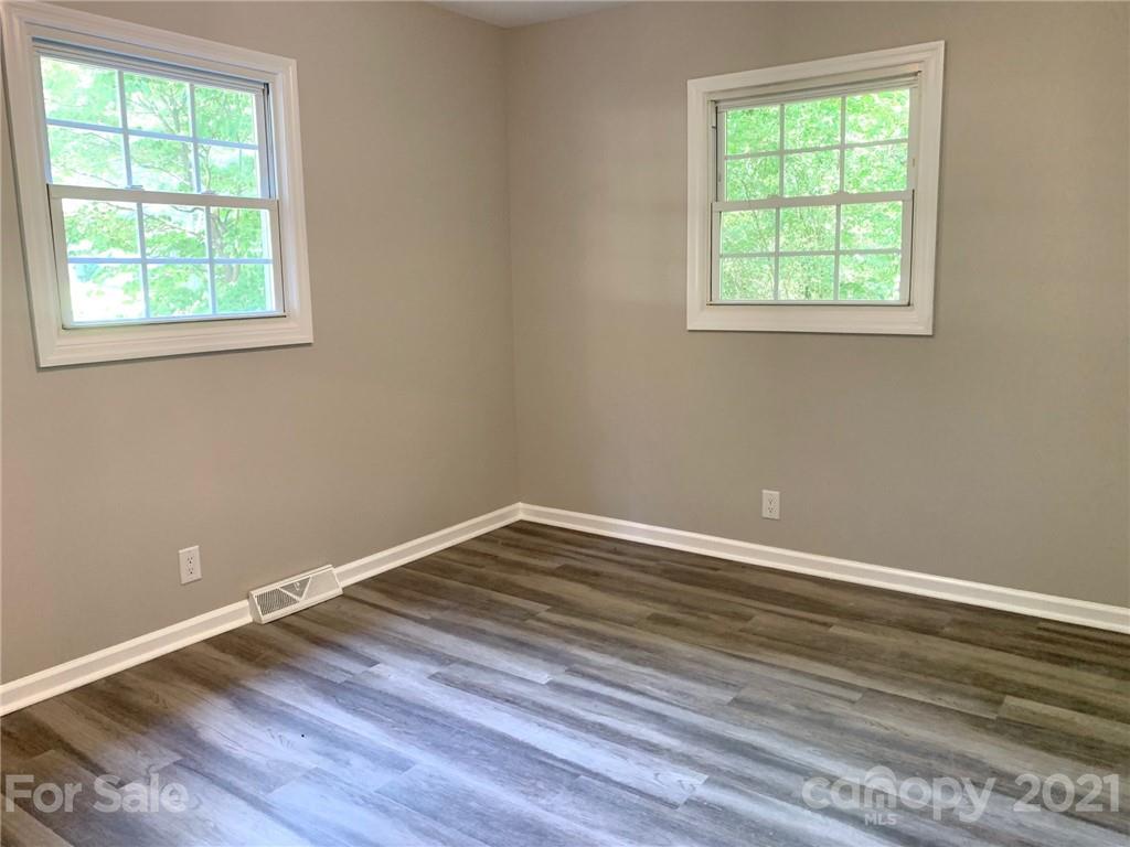 259 Roberta Road Concord, NC 28027 - Photo 10 of 12 an empty room with wooden floor and windows