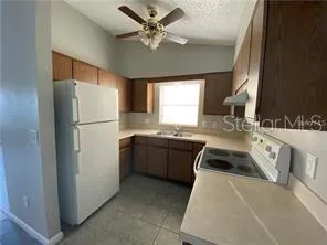 a kitchen with stainless steel appliances a refrigerator sink and cabinets
