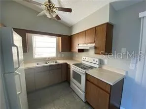 a kitchen with a sink stove and microwave