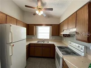 a kitchen with a sink a stove and refrigerator