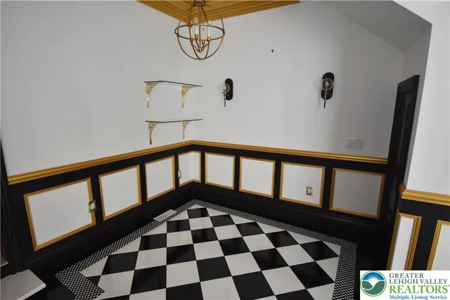 a black and white wall with a black and white checkered floor