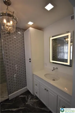 a bathroom with a sink and a mirror