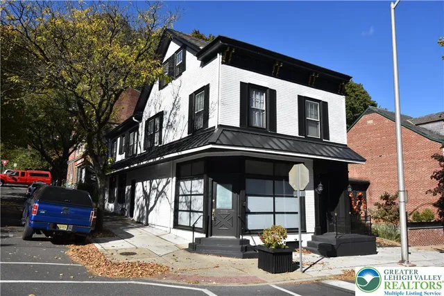 a front view of a house with parking area