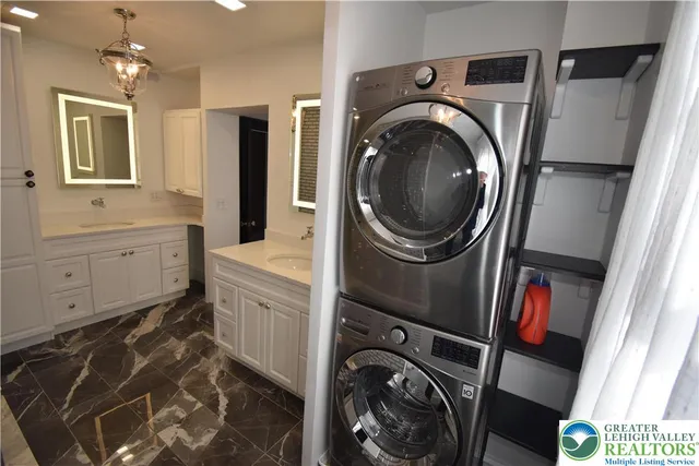 a utility room with sink dryer and washer